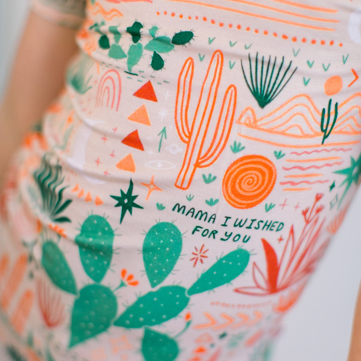Baby wearing cactus print bamboo pajamas in beige colorway with Mama I Wished for You affirmation