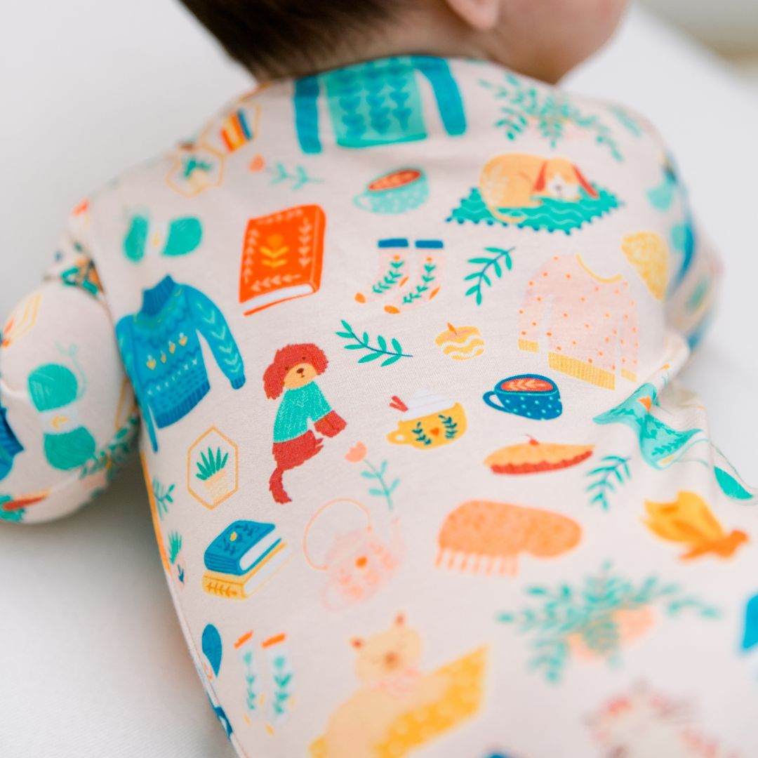 Newborn wearing bamboo clothing with hand-illustrated print