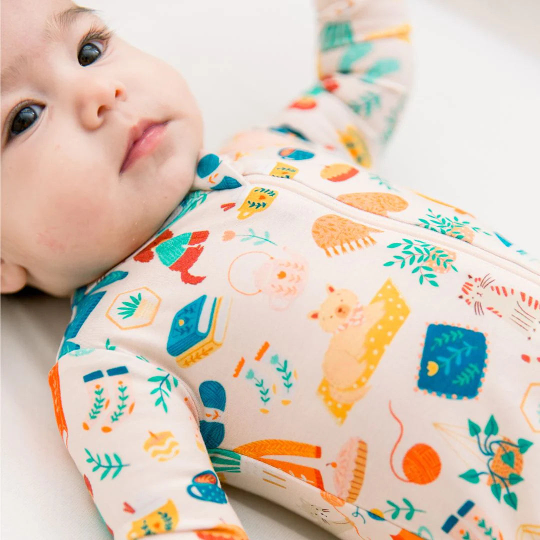 Baby wearing cat and dog print bamboo pajamas from the Cozy Cats & Dogs collection